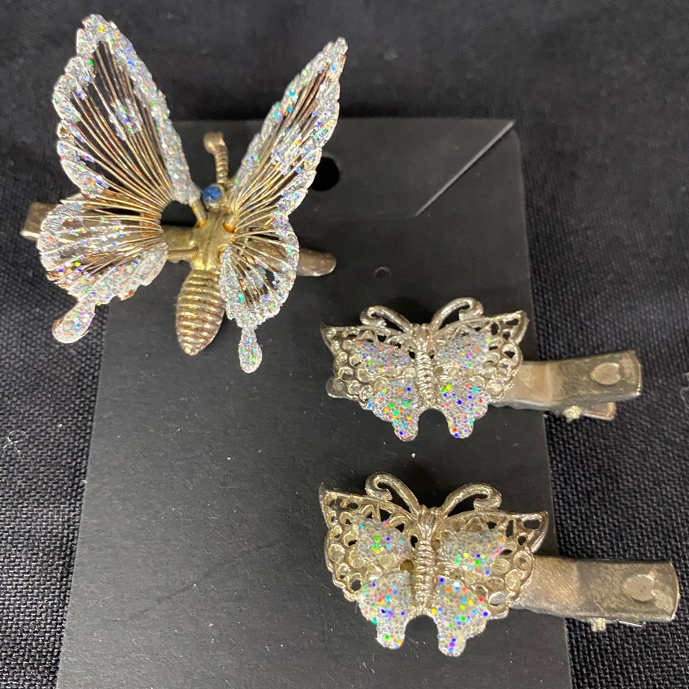 Set of three hair clips, large clip with moving wings and two small butterflies.